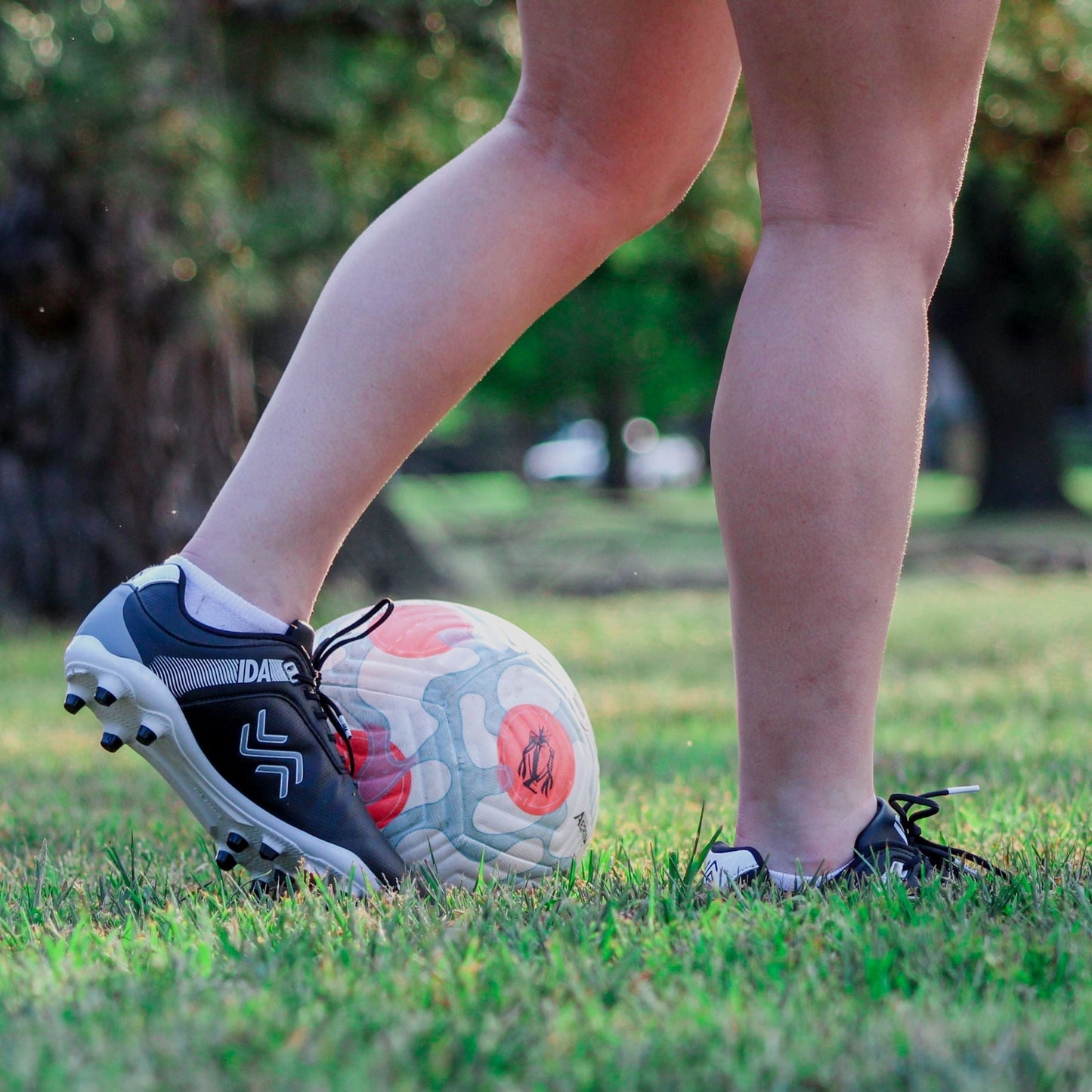 IDA Centra Women's Soccer Cleat, Black, FG/AG, Firm Ground, Artificial Ground, player dribbling on grass field